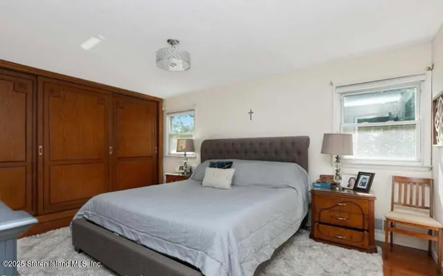 a bedroom with a large bed and a window