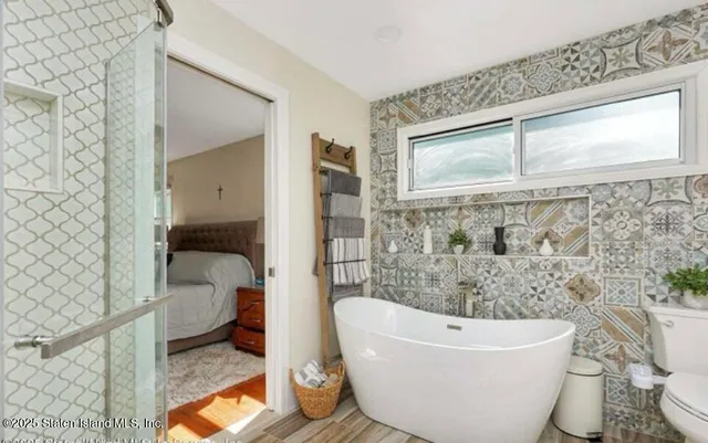 a bathroom with a bathtub and shower