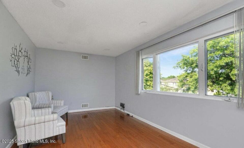 160 Rathbun Avenue Staten Island, NY 10312 - Photo 26 of 37 a view of a livingroom with a couch and a large window with outer view