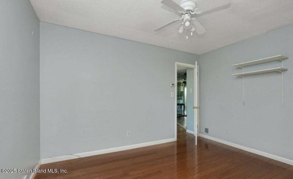 160 Rathbun Avenue Staten Island, NY 10312 - Photo 28 of 37 an empty room with wooden floor fan and window