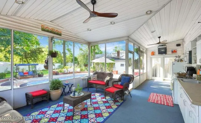 a living room with furniture and a floor to ceiling window