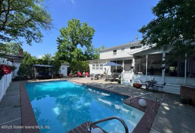 a view of a house with backyard sitting area and garden