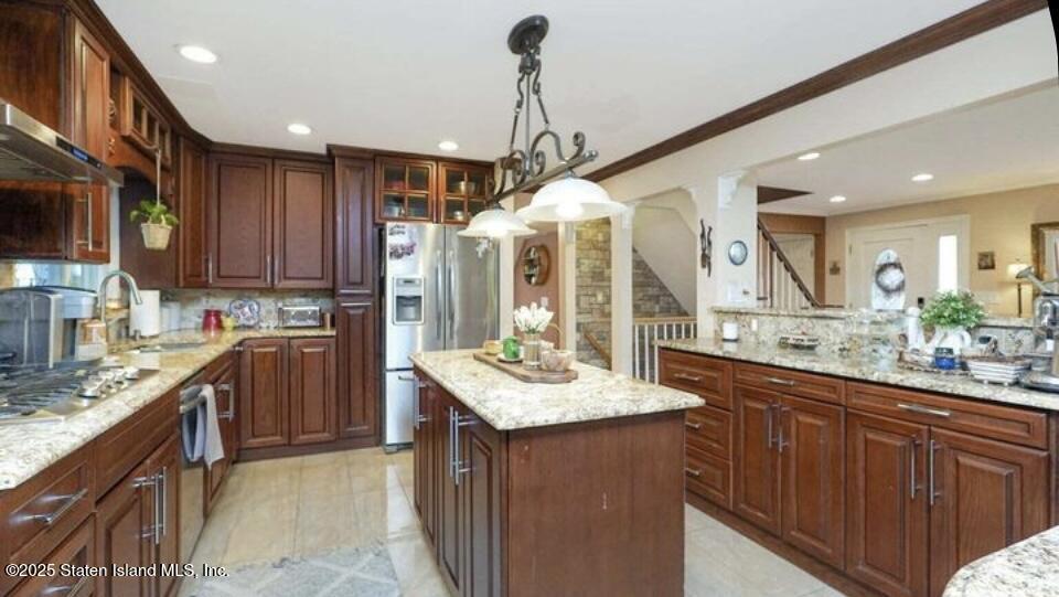 160 Rathbun Avenue Staten Island, NY 10312 - Photo 7 of 37 a kitchen with kitchen island granite countertop stainless steel appliances stove a sink and a refrigerator