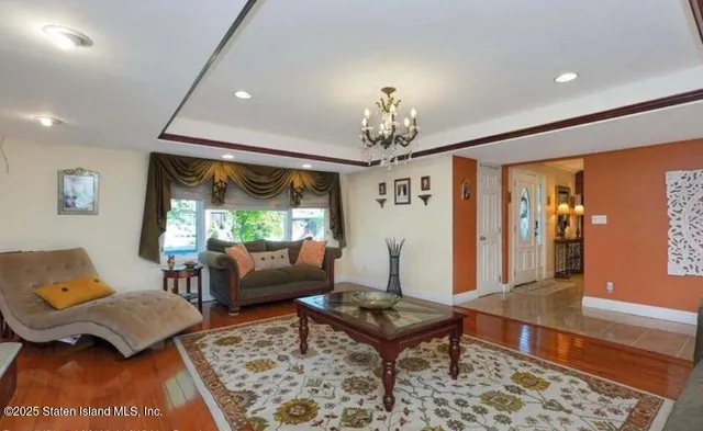 a living room with furniture and a chandelier