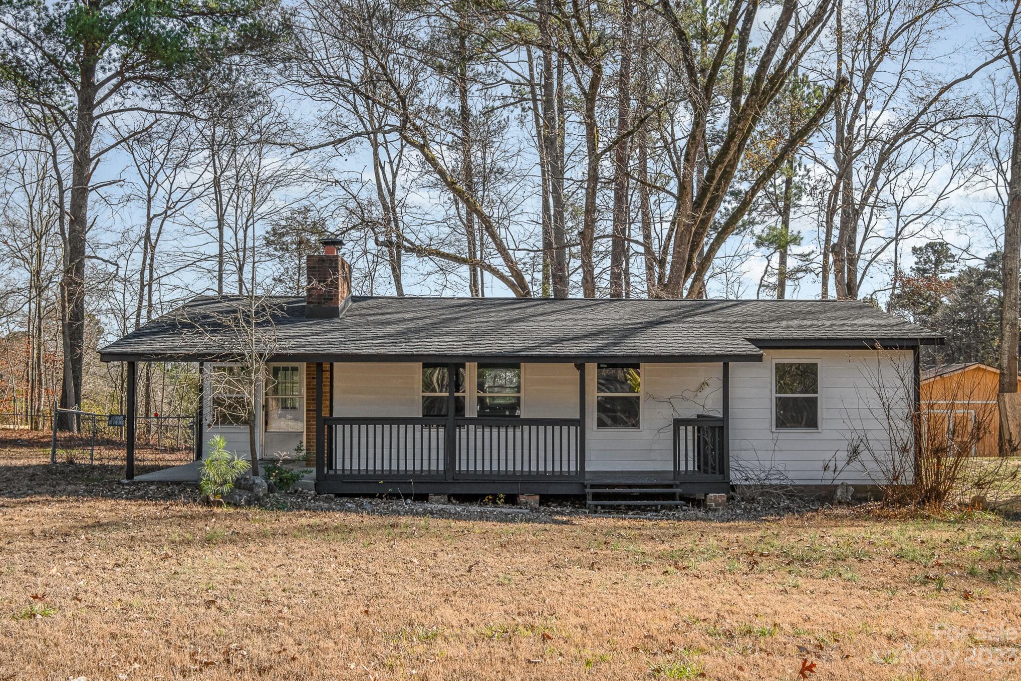 6922 Pear Tree Road Charlotte, NC 28216 - Photo 1 of 26 a house with trees in front of it