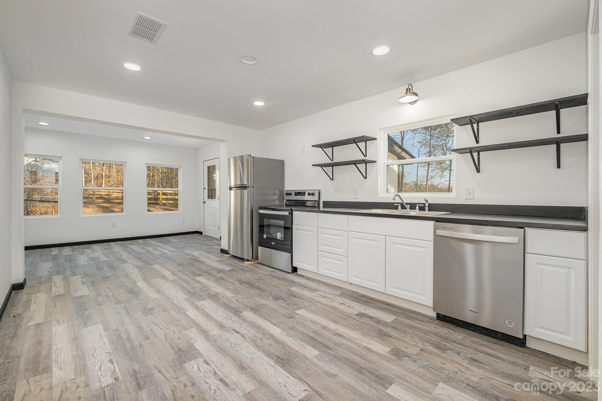 6922 Pear Tree Road Charlotte, NC 28216 - Photo 12 of 26 a kitchen with stainless steel appliances granite countertop a refrigerator and a sink