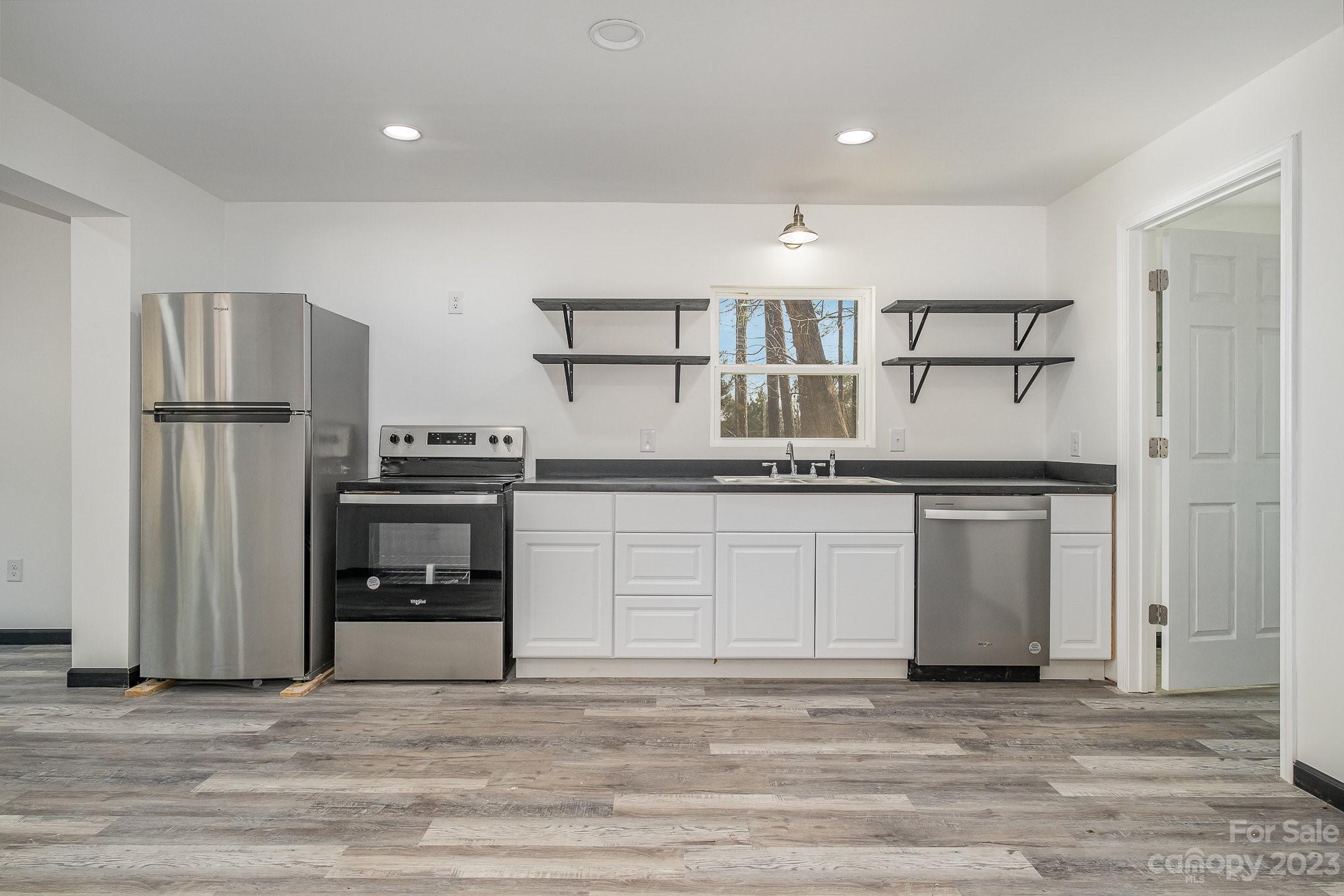 6922 Pear Tree Road Charlotte, NC 28216 - Photo 13 of 26 a kitchen with a refrigerator and a sink