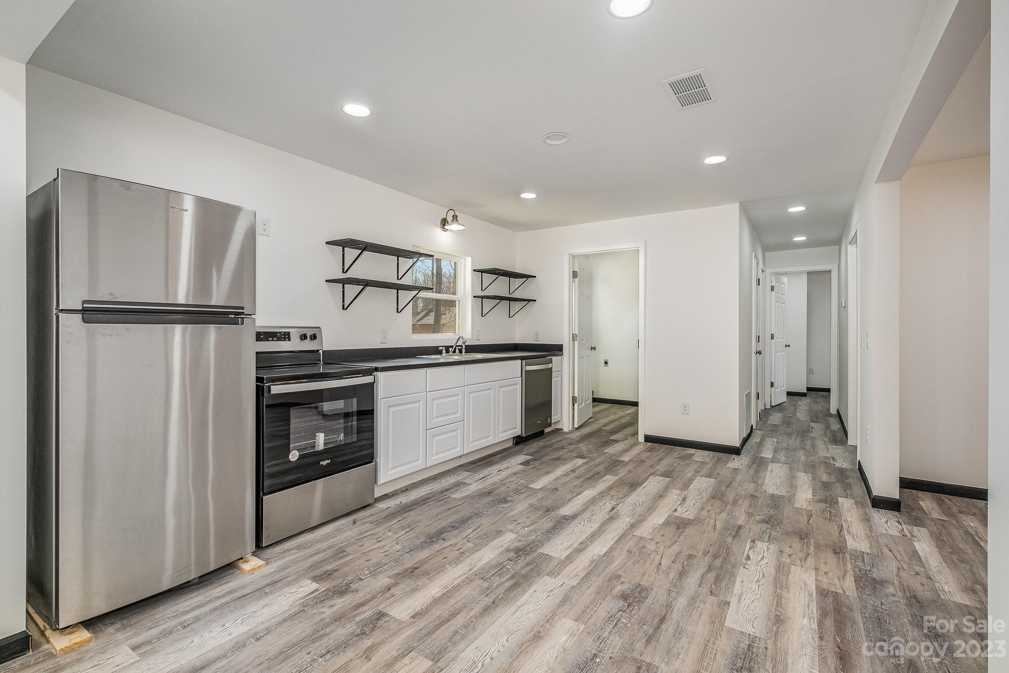6922 Pear Tree Road Charlotte, NC 28216 - Photo 14 of 26 a kitchen with a refrigerator and a stove top oven