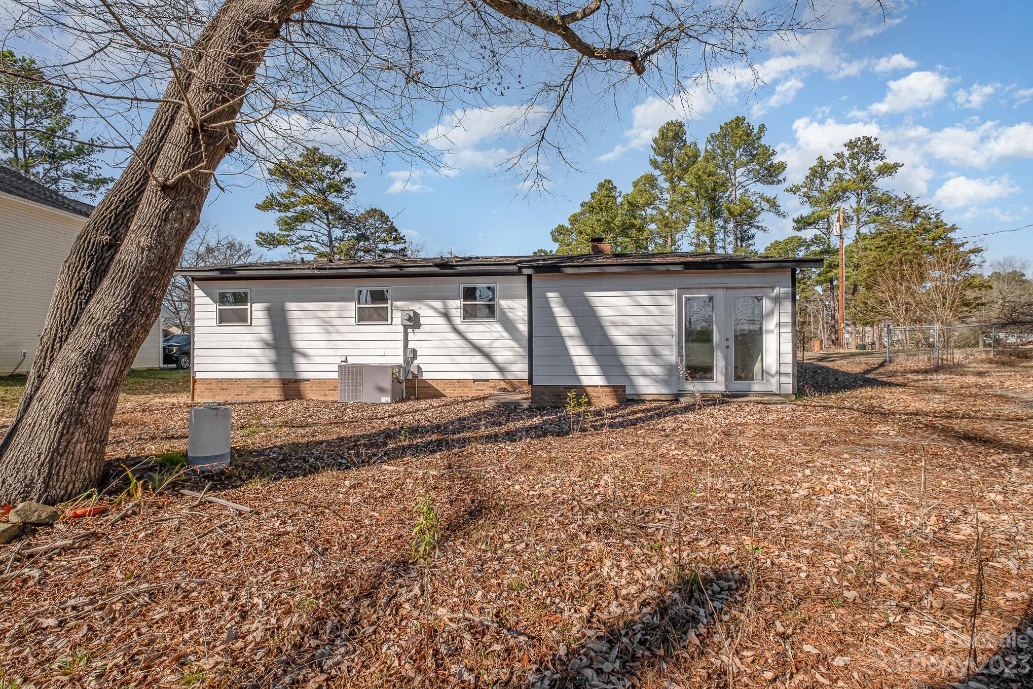 6922 Pear Tree Road Charlotte, NC 28216 - Photo 24 of 26 a house with trees in front of it