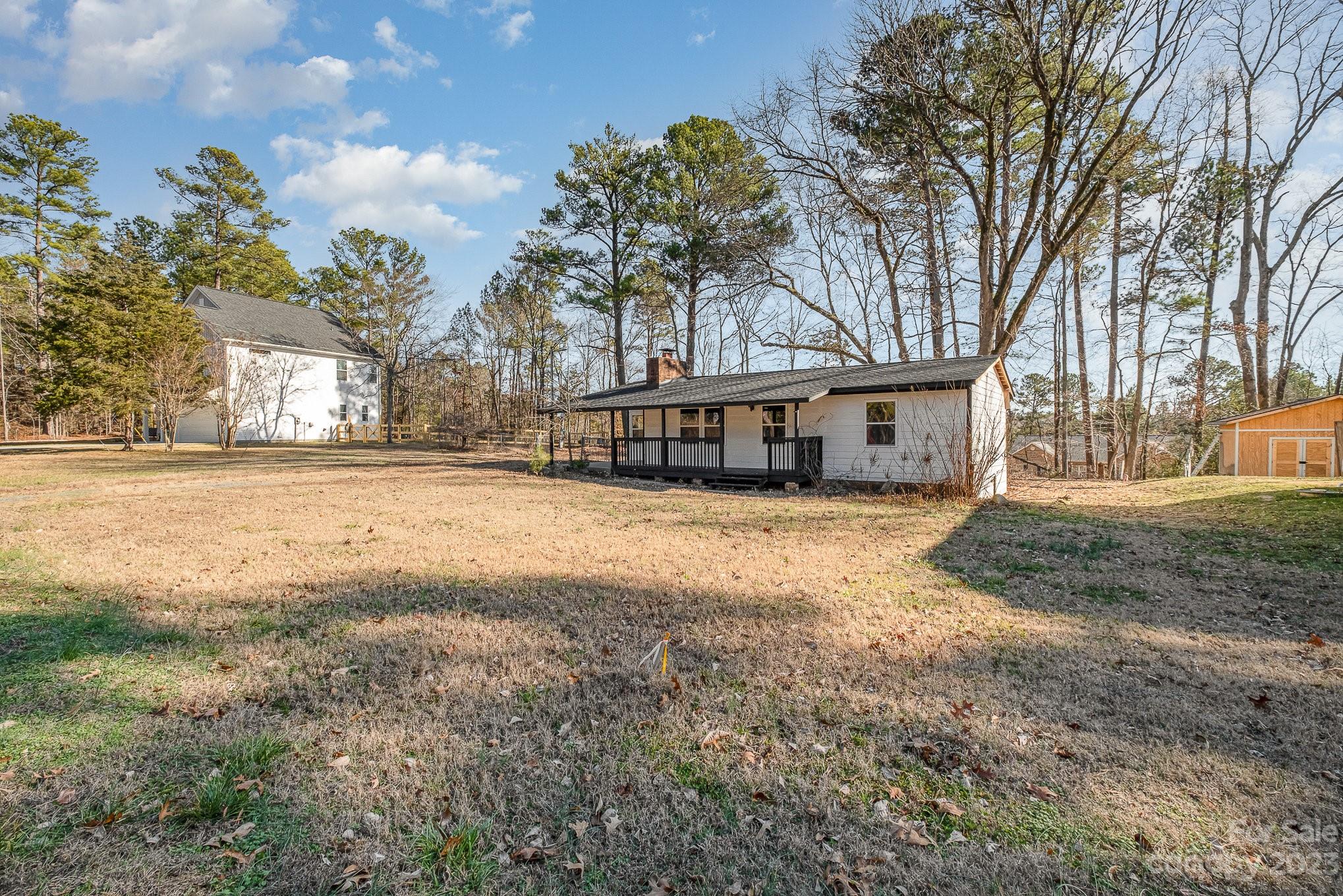 6922 Pear Tree Road Charlotte, NC 28216 - Photo 4 of 26 a house with trees in front of it