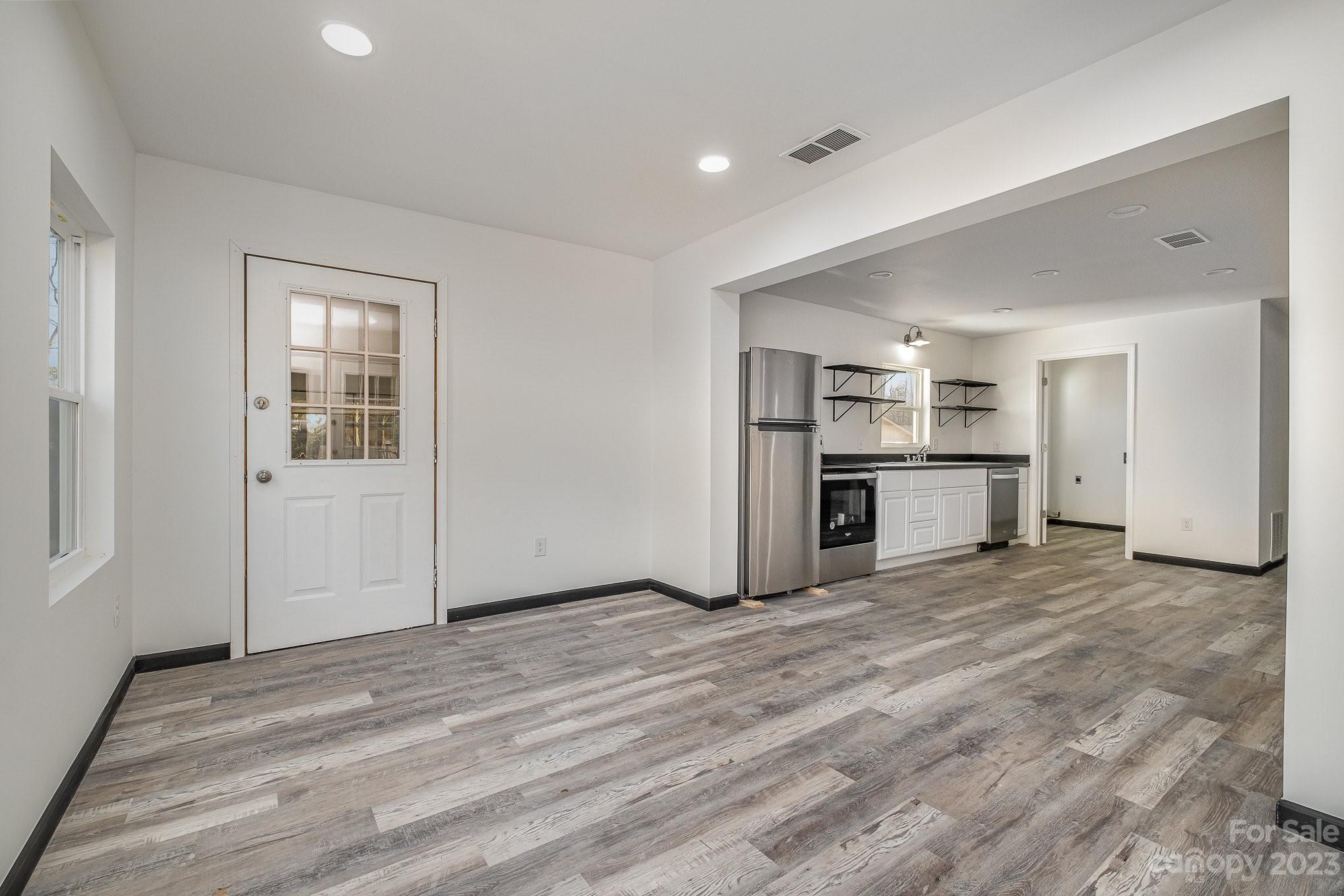 6922 Pear Tree Road Charlotte, NC 28216 - Photo 7 of 26 a view of empty room with kitchen and window