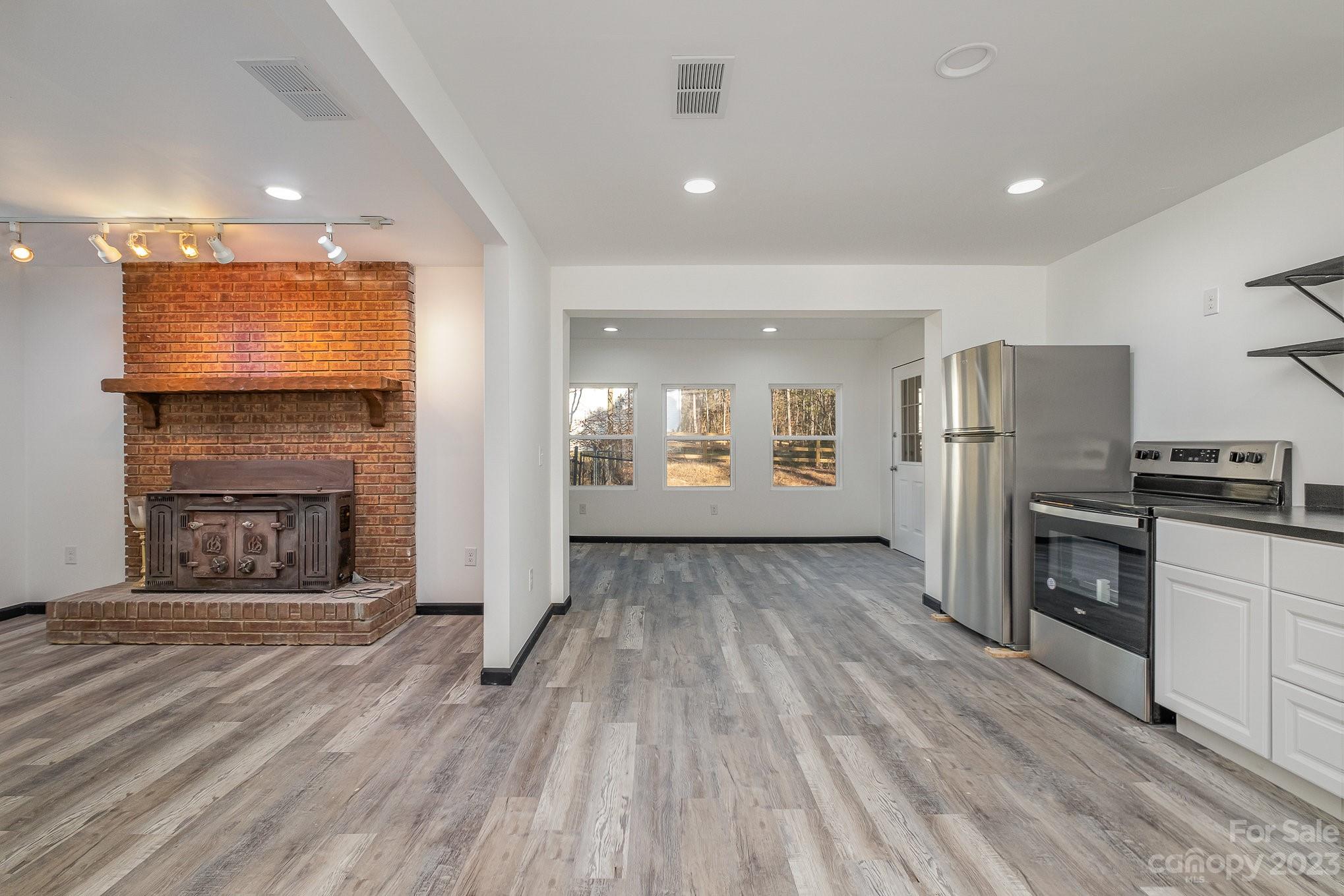 6922 Pear Tree Road Charlotte, NC 28216 - Photo 8 of 26 a view of kitchen with refrigerator microwave and stove top oven