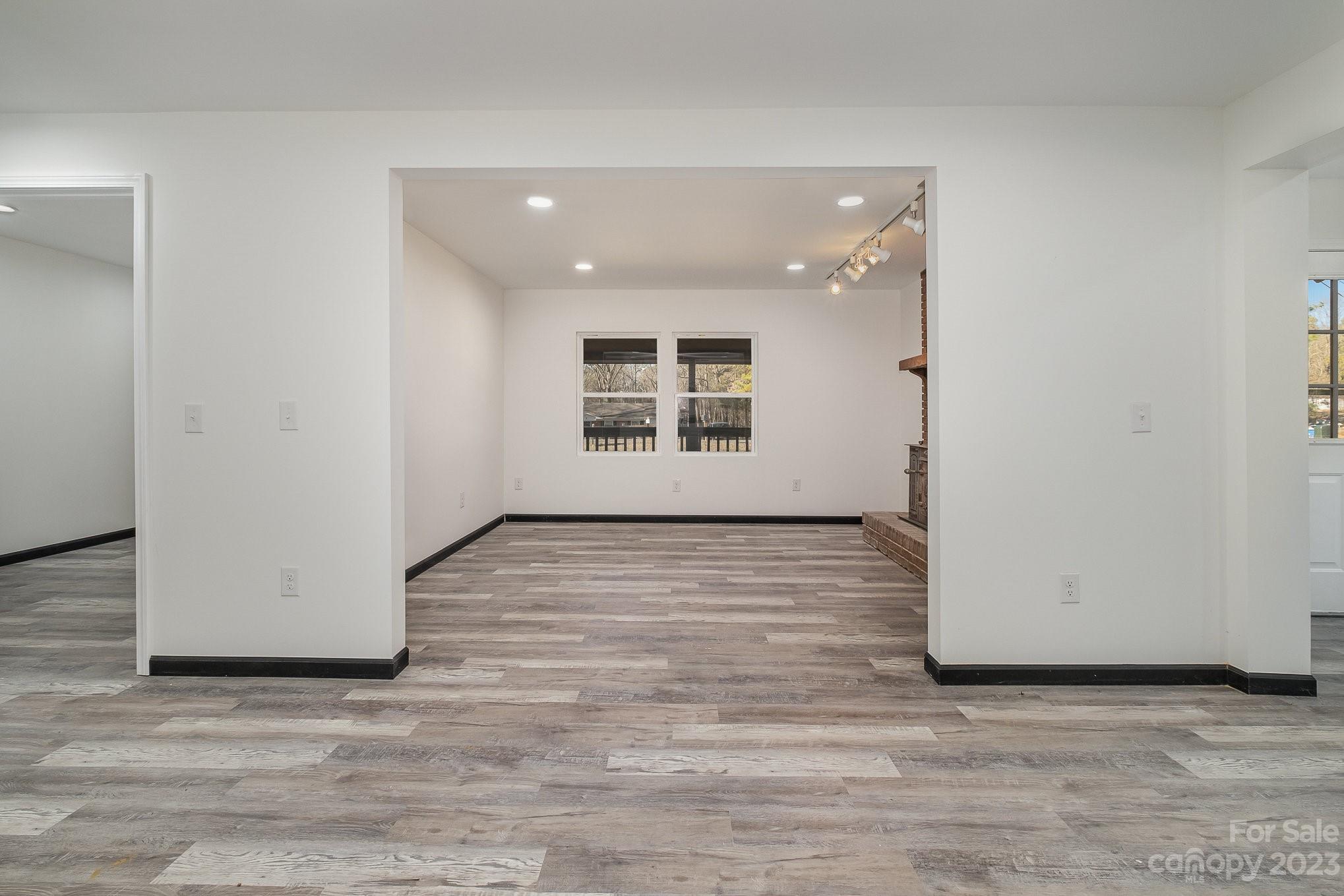 6922 Pear Tree Road Charlotte, NC 28216 - Photo 9 of 26 an empty room with wooden floor and windows