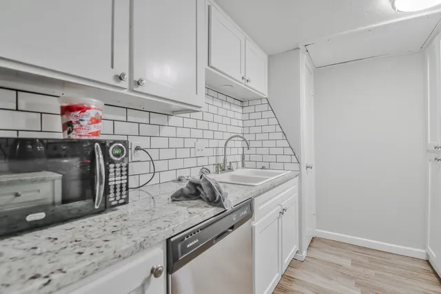a kitchen with a sink stove and cabinets