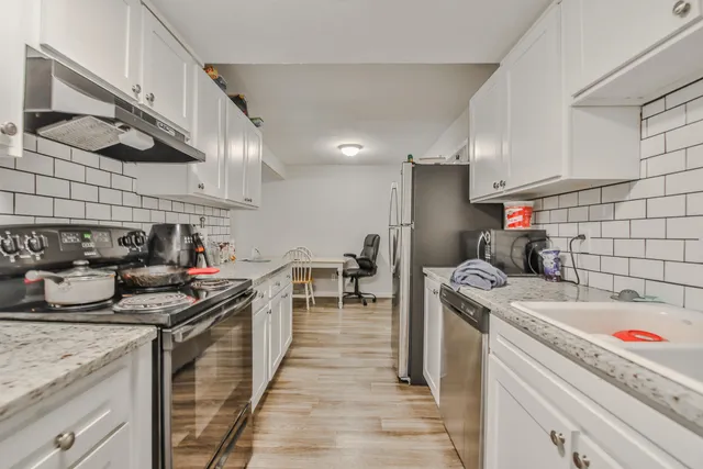a kitchen that has a lot of cabinets in it