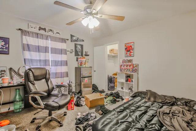 a bedroom with furniture and a chandelier