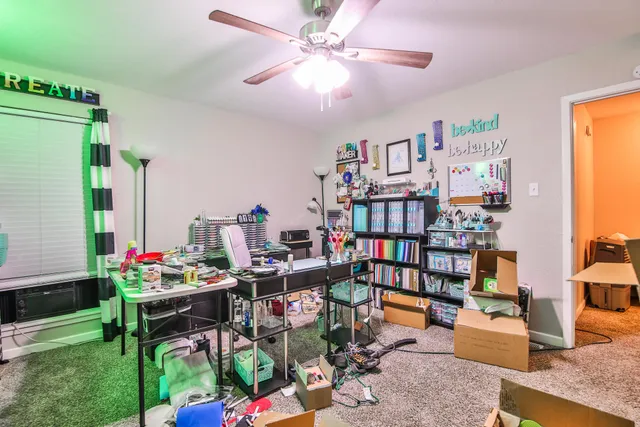 a work room with furniture and a book shelf