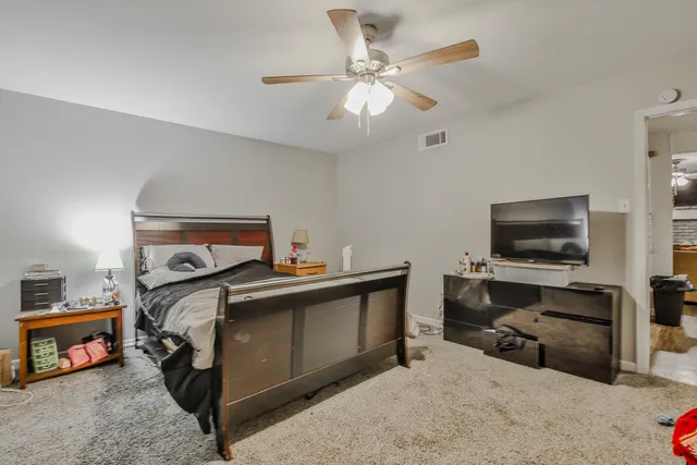 a bedroom with furniture and a flat screen tv