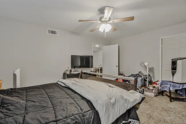 a bedroom with a bed and a flat screen tv