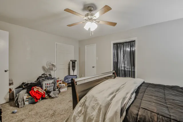 a bedroom that has a bed and a chandelier