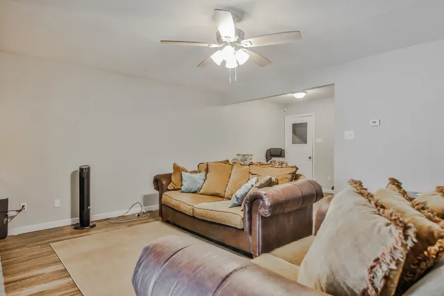 a bed room with a bed and a ceiling fan