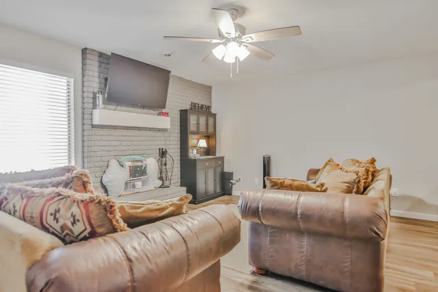 a living room with furniture fireplace and a flat screen tv