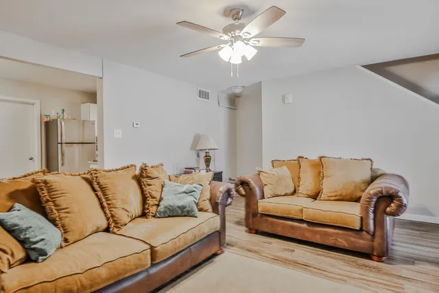 a living room with furniture and a chandelier