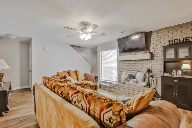 a living room with furniture fireplace and flat screen tv