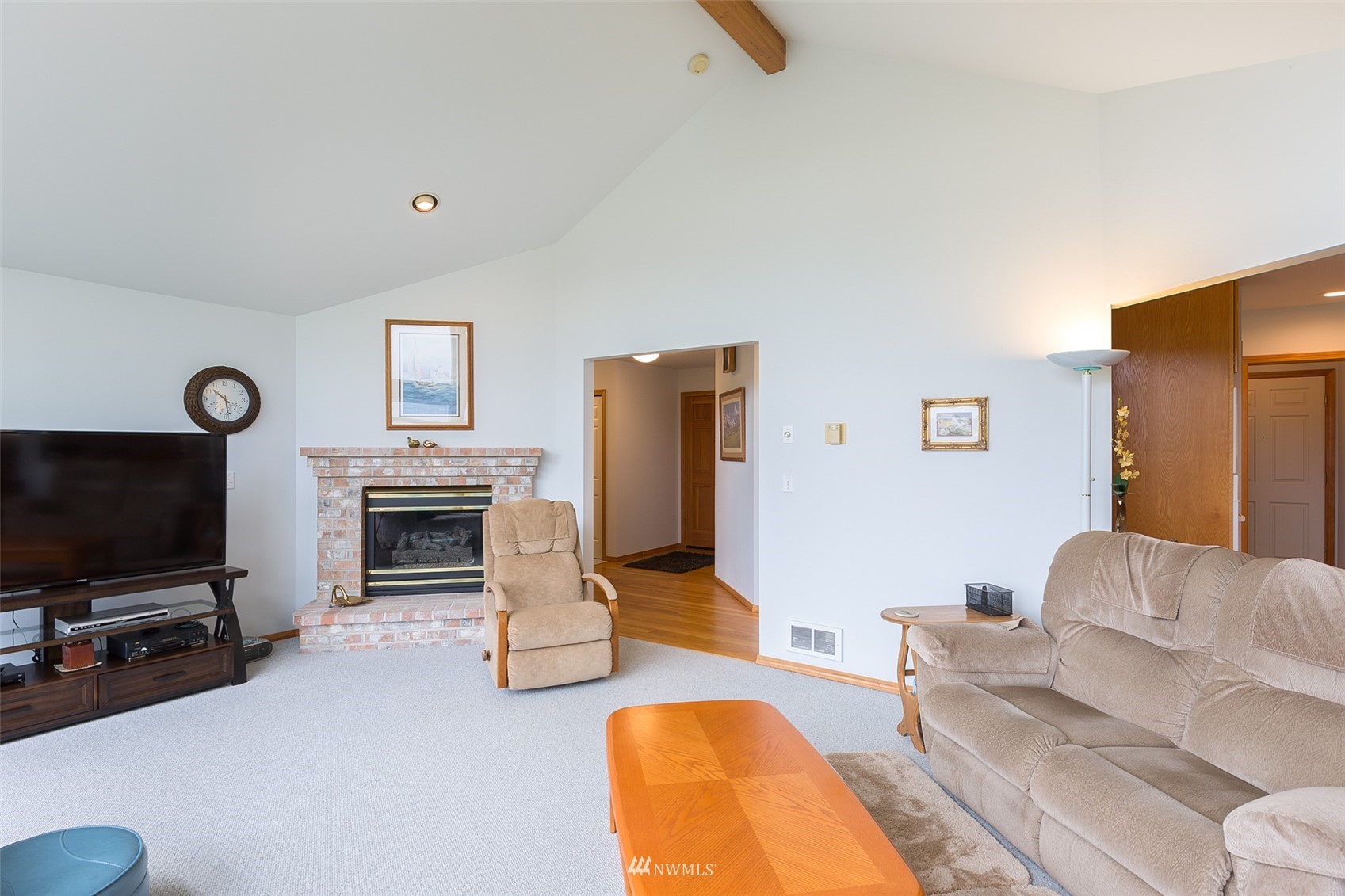 601 East Anderson Road Sequim, WA 98382 - Photo 19 of 37 a living room with furniture a flat screen tv and a fireplace