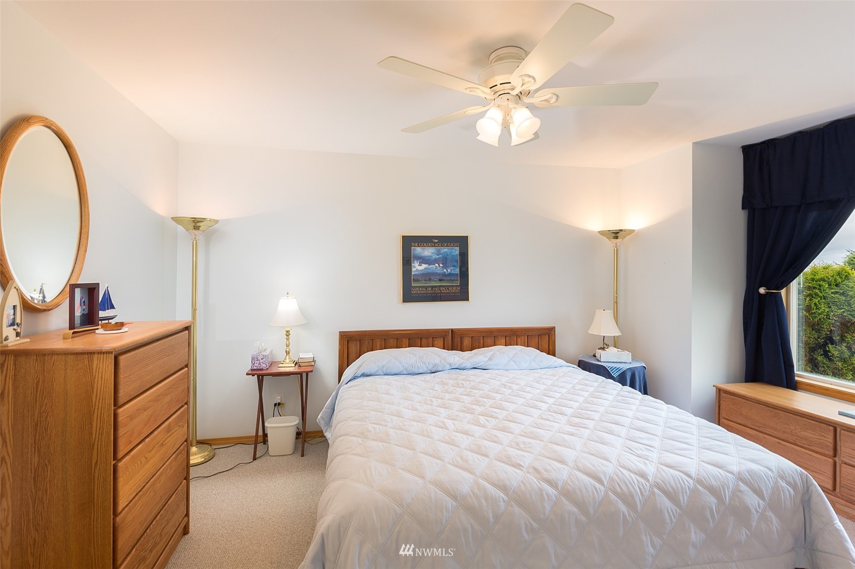 601 East Anderson Road Sequim, WA 98382 - Photo 31 of 37 a bedroom with a large bed and a chandelier