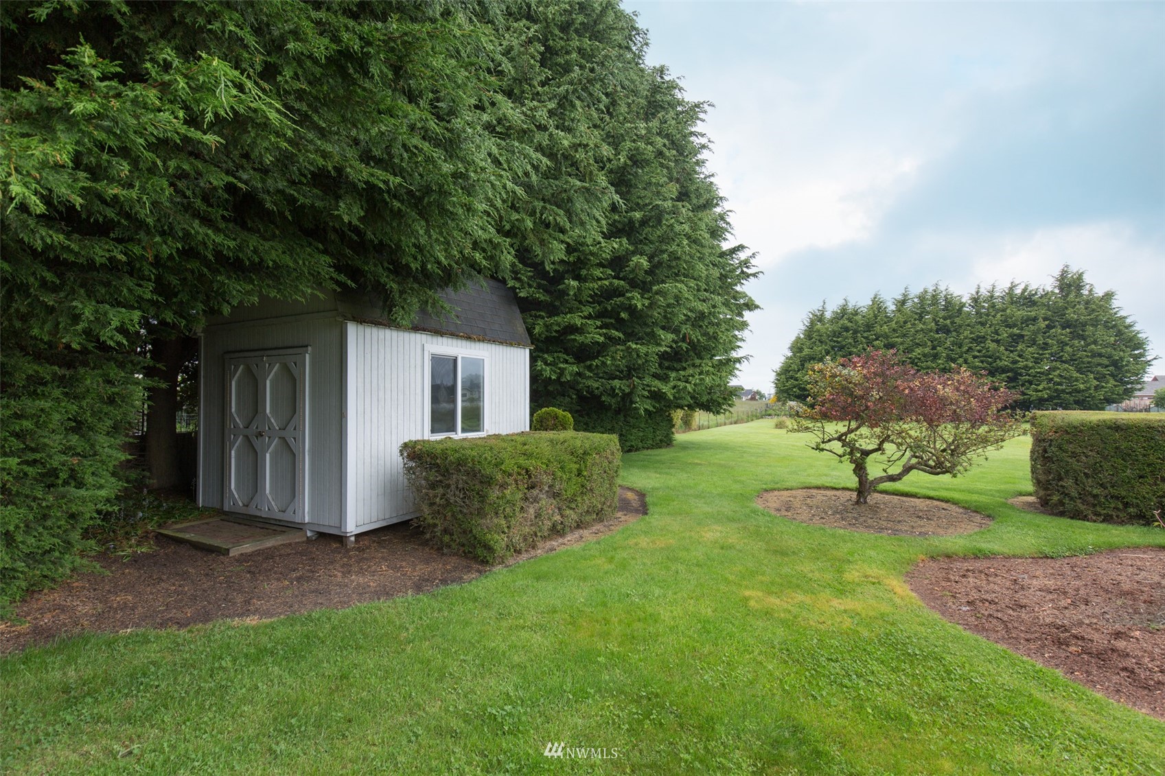 601 East Anderson Road Sequim, WA 98382 - Photo 8 of 37 a view of backyard with table and chairs plants and trees