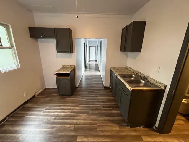 a kitchen with stainless steel appliances a refrigerator a stove top oven a sink and dishwasher