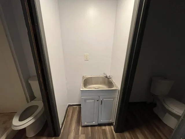 a bathroom with a sink a toilet and a mirror