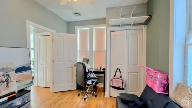 a view of hall way with furniture and wooden floor