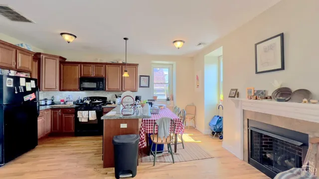 a kitchen with stainless steel appliances granite countertop a stove refrigerator and a sink