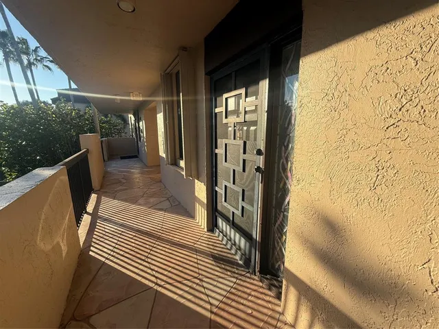 a kitchen with granite countertop a refrigerator and a sink