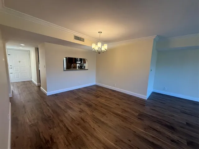 a bathroom with a sink a mirror and wooden floor