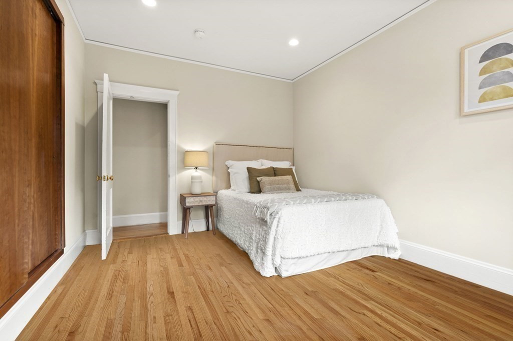 46 Gardner Road, Unit 2 Brookline, MA 02445 - Photo 20 of 38 a bedroom with a bed and wooden floor