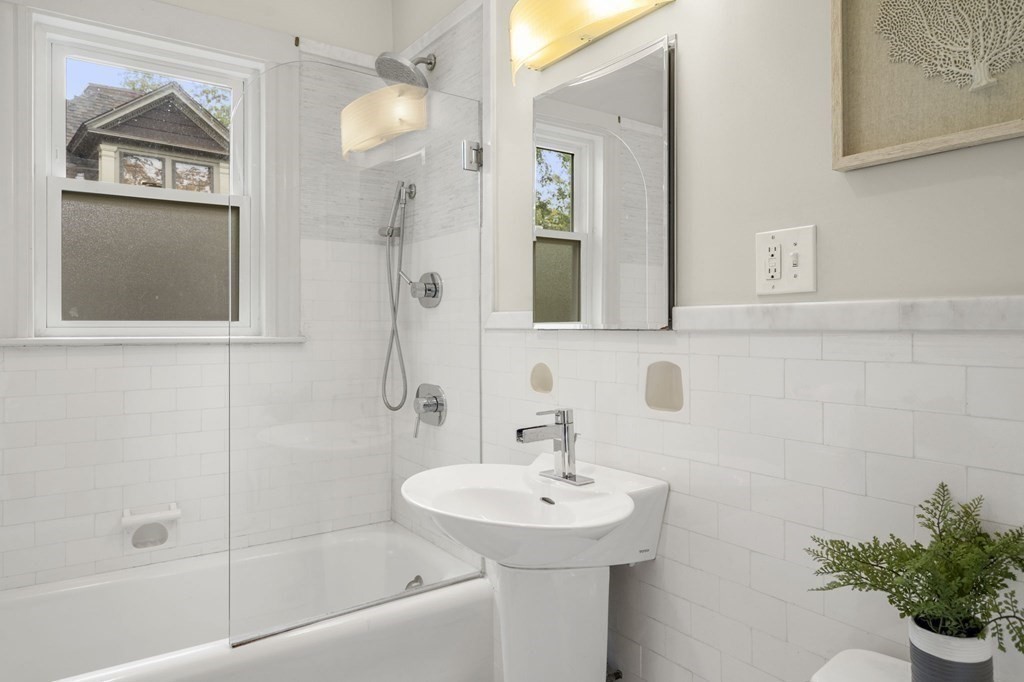 46 Gardner Road, Unit 2 Brookline, MA 02445 - Photo 23 of 38 a bathroom with a sink a mirror and a shower