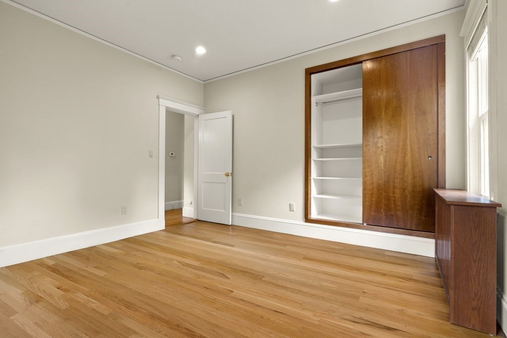 46 Gardner Road, Unit 2 Brookline, MA 02445 - Photo 25 of 38 a view of an empty room with wooden floor and a window