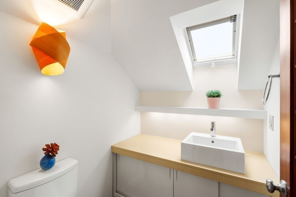 46 Gardner Road, Unit 2 Brookline, MA 02445 - Photo 32 of 38 a bathroom with a sink and a mirror