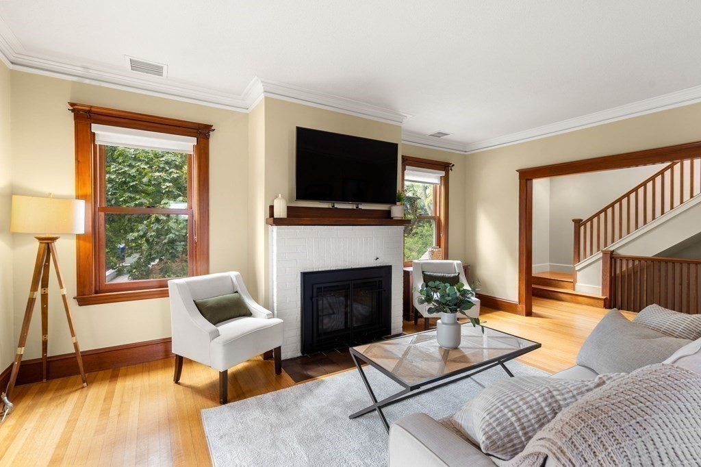 46 Gardner Road, Unit 2 Brookline, MA 02445 - Photo 4 of 38 a living room with furniture a flat screen tv and a fireplace