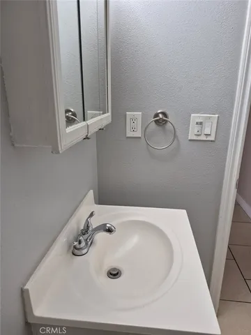 a bathroom with a sink and mirror