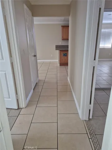 a hallway view with staircase