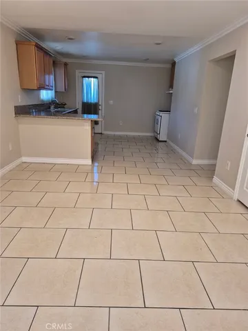 a view of a livingroom with wooden floor and a sink
