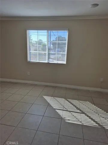 a view of a livingroom with an empty space and a window