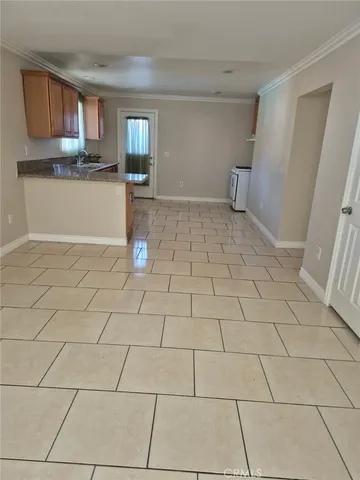 a view of a livingroom with wooden floor and a cabinet