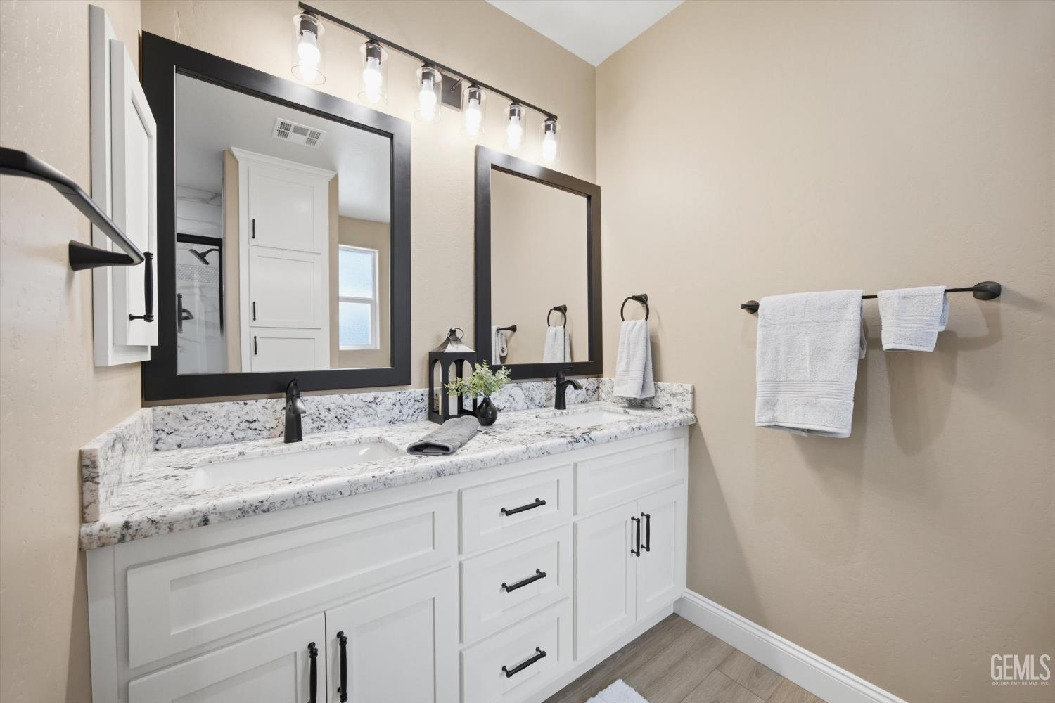 Undisclosed Address Tehachapi, CA 93561 - Photo 32 of 47 a bathroom with a double vanity sink and mirror