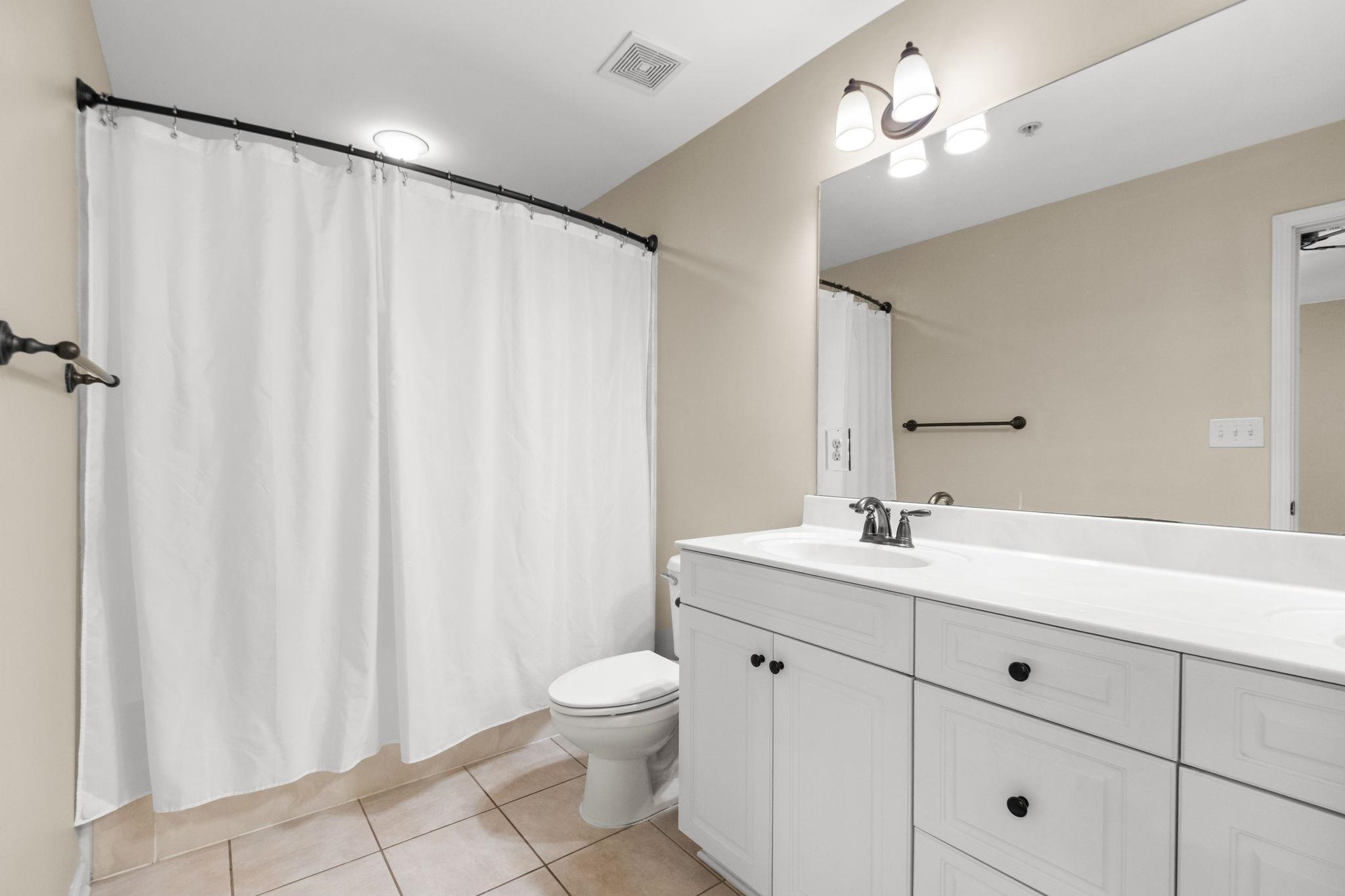 2275 McVay Road, Unit 2275 Germantown, TN 38138 - Photo 29 of 40 a bathroom with a toilet a sink and a mirror