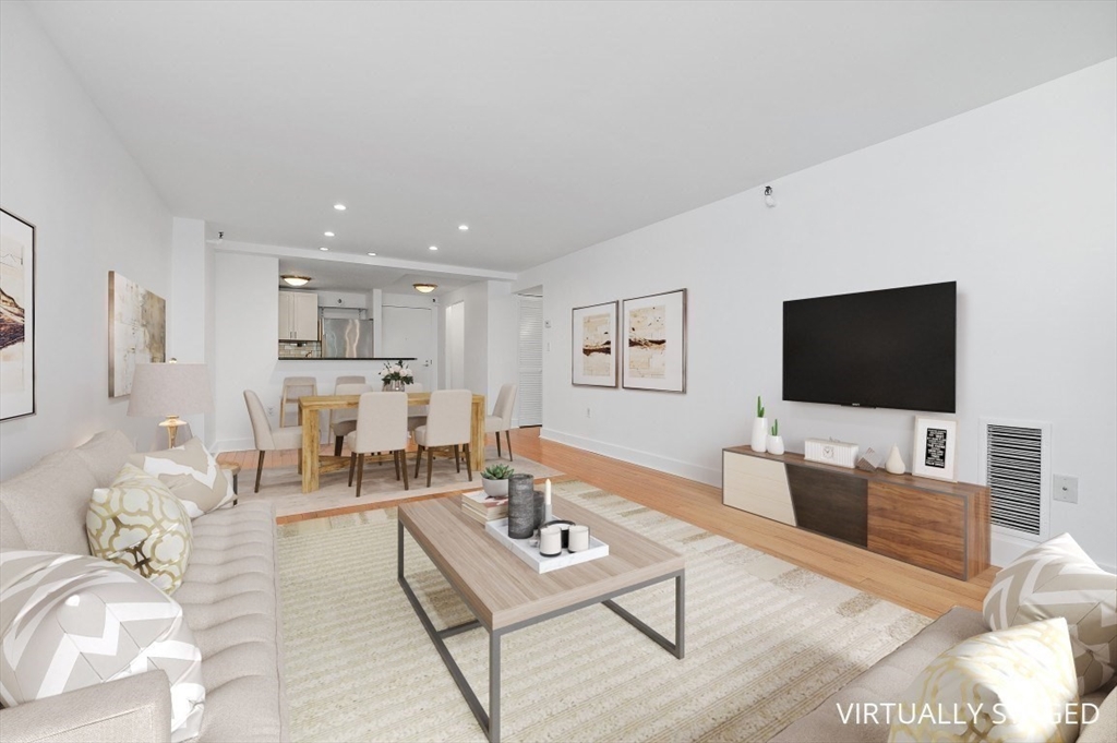 42 8th Street, Unit 1315 Boston, MA 02129 - Photo 2 of 20 a living room with furniture and a flat screen tv